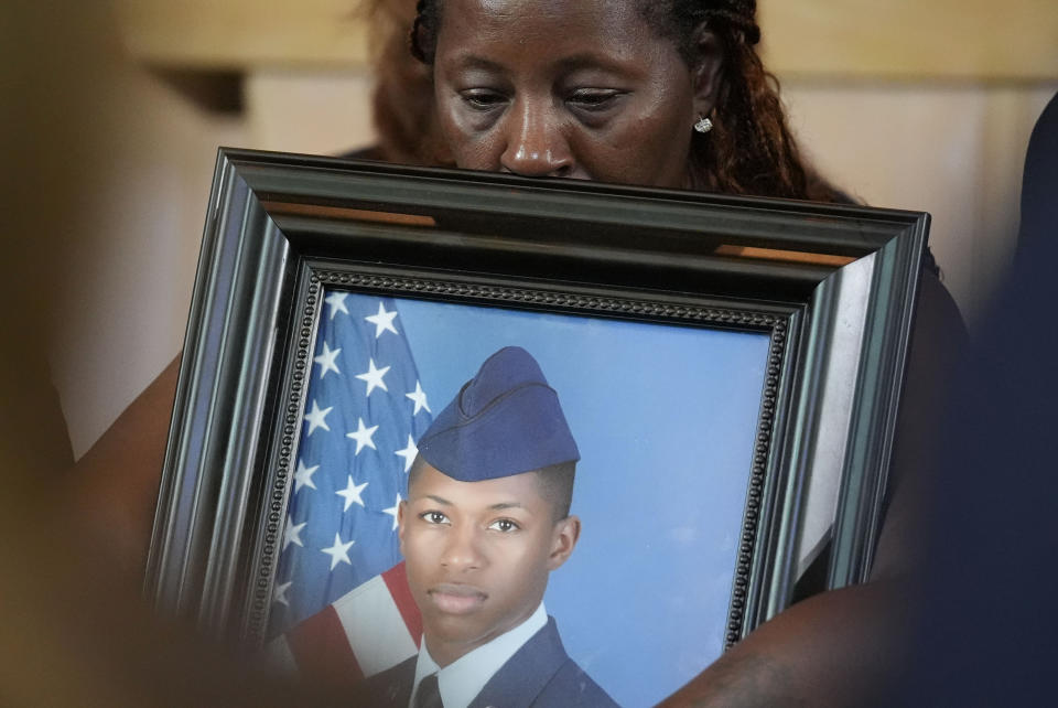 Chantemekki Fortson, mother of slain Roger Fortson, a U.S. Air Force senior airman, holds a photo of her son during a news conference with attorney Ben Crump on Monday, June 3, 2024, in Atlanta. (AP Photo/Brynn Anderson)