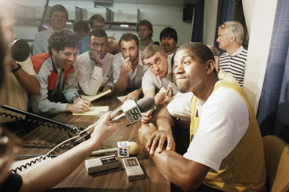 FILE - The Los Angeles Lakers' Earvin "Magic" Johnson pauses for a moment's thought during a question and answer period, June 1, 1987, at the Forum in Inglewood, Calif., where the Lakers will meet the Boston Celtics in game one of the NBA Championship series. (AP Photo/Lennox McLendon, File)