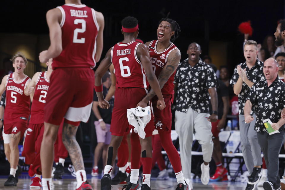 Arkansas' Khalif Battle (0) and Arkansas' Layden Blocker celebrate after a dunk from Blocker gave them a three-point lead at the end of the first half of an NCAA college basketball game in the Battle 4 Atlantis at Paradise Island, Bahamas, Friday, Nov. 24, 2023. (Tim Aylen/Bahamas Visual Services via AP)