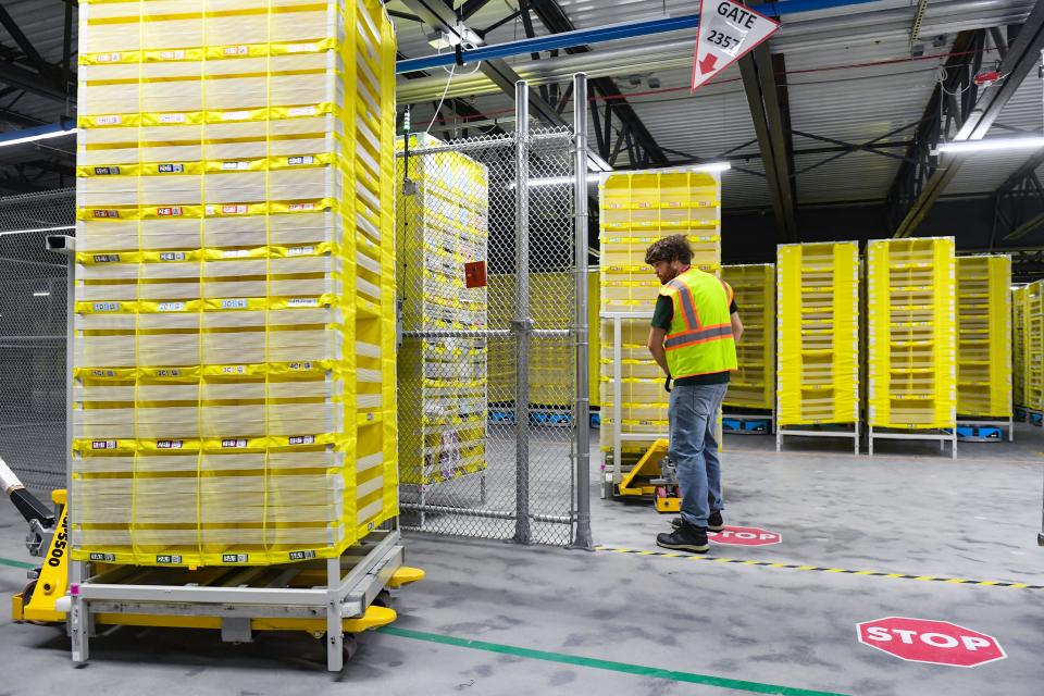 Jake Duffy moves empty pods outside the transfer area to be filled inside the new Amazon Fulfillment Center on Thursday, October 13, 2022, in Sioux Falls.