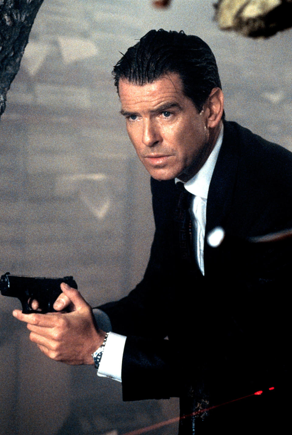 Pierce Brosnan as James Bond holding a gun