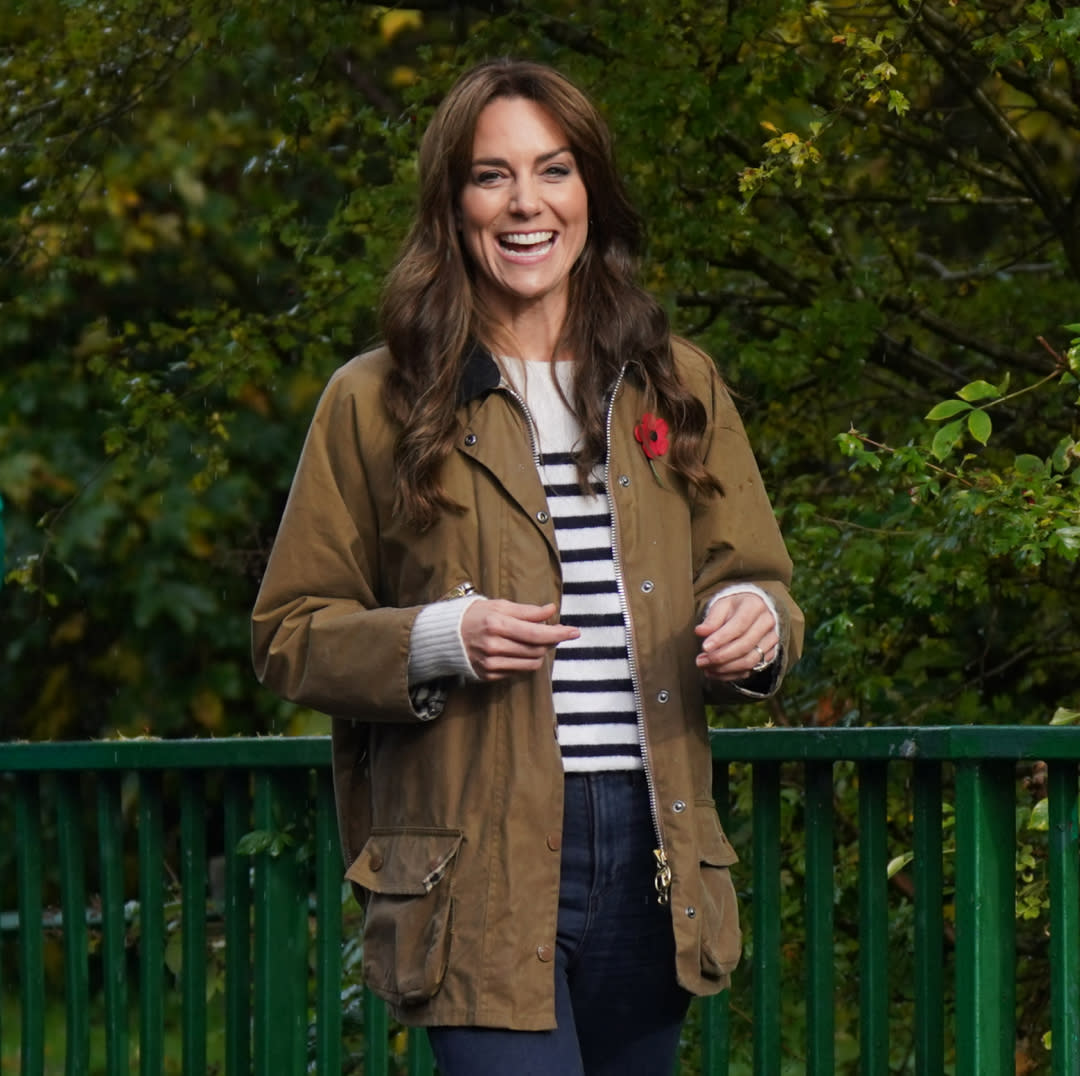  Kate Middleon wears a Breton stripe sweater and a Barbour rain jacket. 