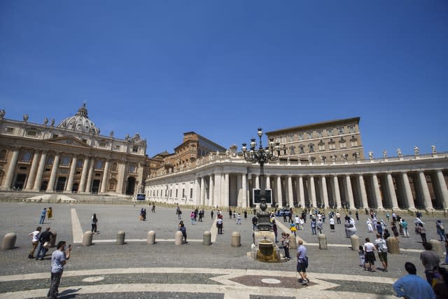 People wait for Pope Francis to deliver his blessing from his window in St Peter’s Square, at the Vatican 