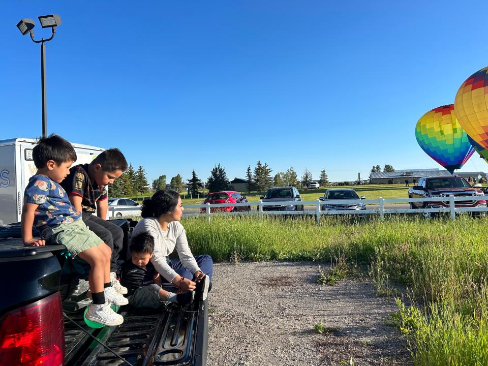 Alexis Luna, 20, watches the Teton Valley Balloon Festival with her three nephews. She graduated high school during the COVID-19 pandemic, and has put off any plans for postsecondary education while trying to make ends meet in one of the most expensive rural regions in America.