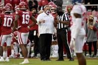 Arkansas coach Sam Pittman, center, talks with an official during the second half of an NCAA college football game against Mississippi, Saturday, Oct. 17, 2020, in Fayetteville, Ark. (AP Photo/Michael Woods)