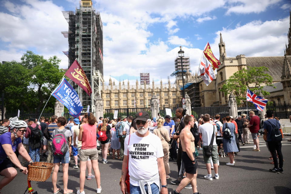 Anti-lockdown and anti-vaccine demonstrators gather at the gates of the Houses of Parliament during a protest, amid the coronavirus disease (COVID-19) pandemic, London, Britain, June 14, 2021. REUTERS/Henry Nicholls