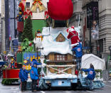 The characters Santa Claus and Mrs. Claus are helped from their float at the end of the modified Macy's Thanksgiving Day Parade in New York, Thursday, Nov. 26, 2020. Due to the pandemic, crowds of onlookers were not allowed to attend the annual parade. (AP Photo/Craig Ruttle)