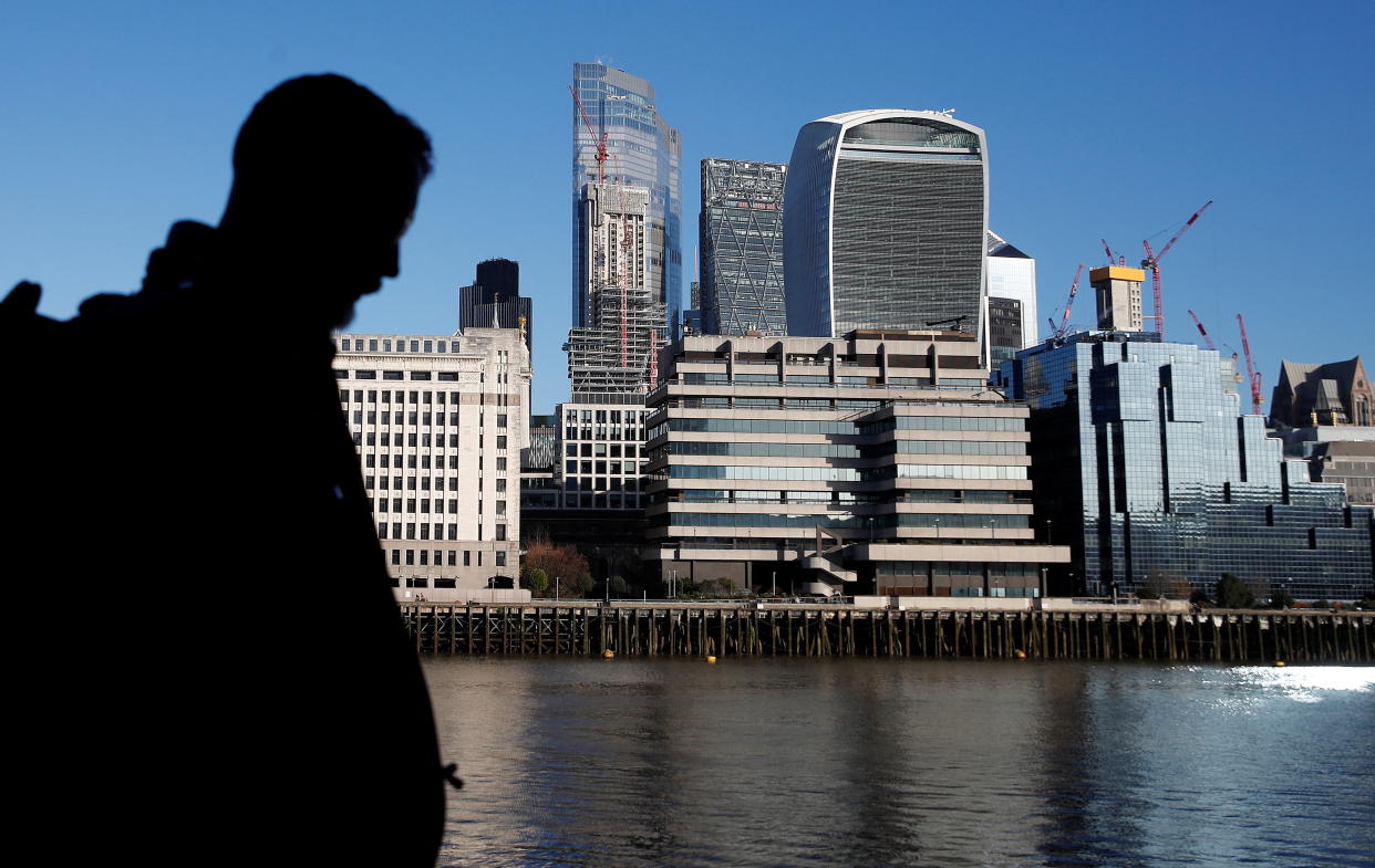 FTSE 100 A man walks near the City of London financial district amid the spread of the coronavirus disease (COVID-19), in London, Britain, January 20, 2022.  REUTERS/Peter Nicholls