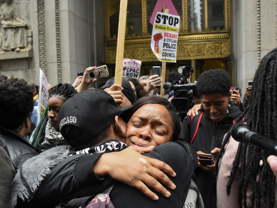 People react outside of City Hall after a jury convicted white Chicago police Officer Jason Van Dyke of second-degree murder in the 2014 shooting of black teenager Laquan McDonald Friday, Oct 5, 2018, in Chicago. Van Dyke was charged with first degree-murder in the October 2014 killing, a charge that requires a finding that the shooting was unnecessary and unreasonable. (AP Photo/Matt Marton)