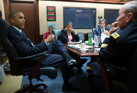 President Barack Obama meets with the National Security Council in the Situation Room of the White House in Washington, in this handout photograph taken and released on August 7, 2014. REUTERS/Pete Souza/White House/Handout