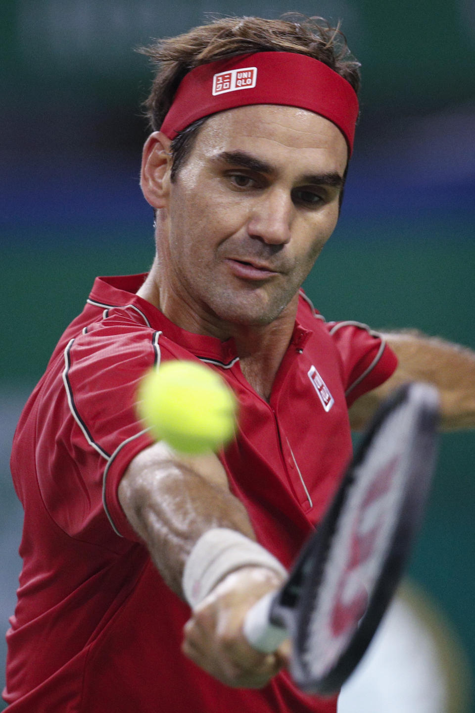 Roger Federer of Switzerland hits a return shot against Albert Ramos-Vinolas of Spain during their men's singles match at the Shanghai Masters tennis tournament at Qizhong Forest Sports City Tennis Center in Shanghai, China, Tuesday, Oct. 8, 2019. (AP Photo/Andy Wong)