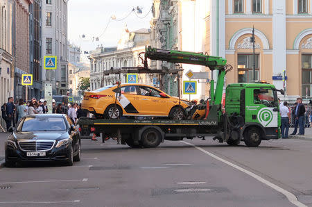 A damaged taxi, which ran into a crowd of people, is evacuated in central Moscow, Russia June 16, 2018. REUTERS/Staff