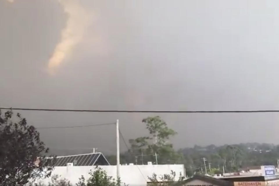 In this Tuesday, Dec. 31, 2019, image from video, fires are seen from Batehaven, near Batemans Bay, New South Wales, Australia. Thousands of tourists fled Australia's wildfire-ravaged eastern coast Thursday, Jan. 2, 2020, ahead of worsening conditions as the military started to evacuate people trapped on the shore further south. (Josh Aldwell via AP)