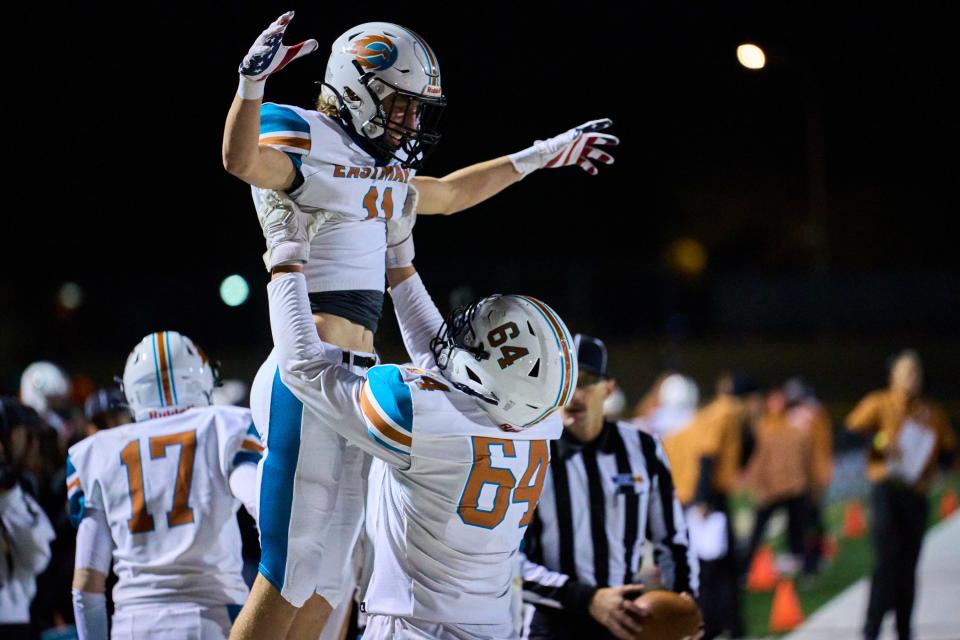 Nov 26, 2022; phoenix, az, usa; Eastmark Firebirds wide receiver Austin Johnston (11) is hoist into the air by tackle Reese Quiroz (64) after scoring a touchdown against the Thatcher Eagles during the 3A AIA State Championship game at Desert Vista High Schoolâ€™s football field in Phoenix on Saturday, Nov. 26, 2022. Mandatory Credit: Alex Gould/The Republic