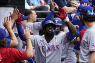 Texas Rangers' Adolis Garcia celebrates with teammates after hitting a three-run home run during the fifth inning of a baseball game against the Chicago White Sox in Chicago, Saturday, June 11, 2022. (AP Photo/Nam Y. Huh)