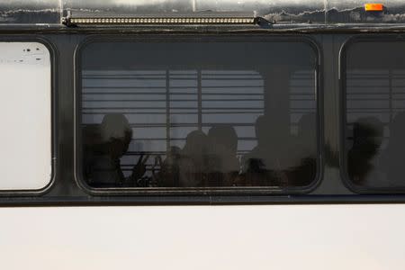 FILE PHOTO: A federal bus full of detainees arrives as Immigration and Customs Enforcement (ICE) delivers immigration detainees to FCI Victorville federal prison in Victorville, California, U.S. June 8, 2018. REUTERS/Patrick T. Fallon/File Photo