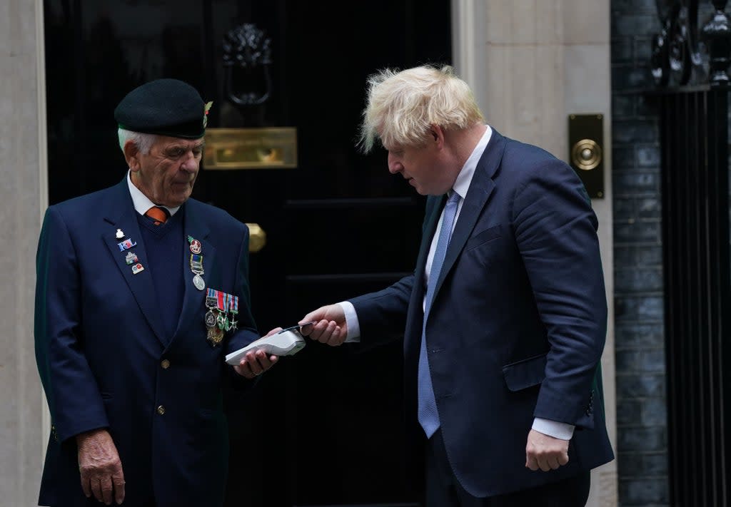 Prime Minister Boris Johnson using the card machine to donate to the poppy appeal (Steve Parsons/PA) (PA Wire)