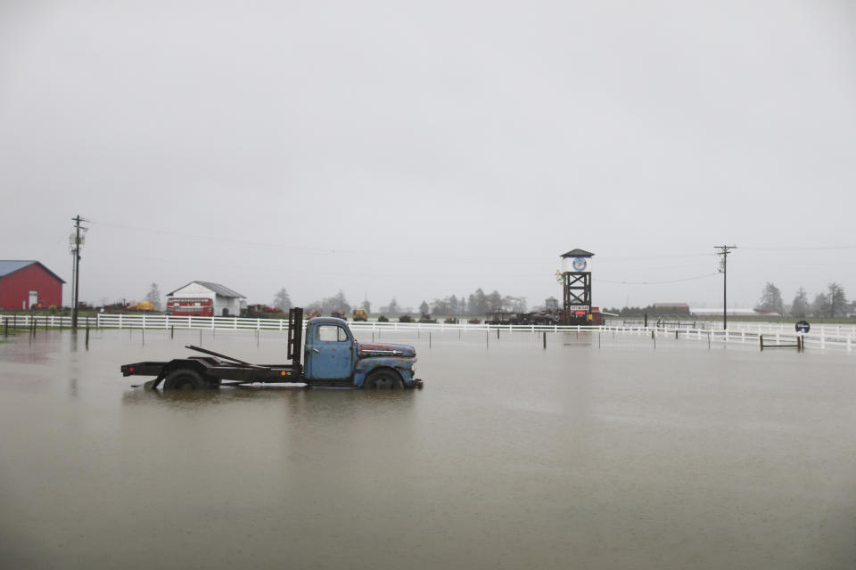 Heavy rain causes flooding outside Blue Heron French Cheese Company along Highway 101 in Tillamook, Ore., Tuesday, Dec. 5, 2023. (Dave Killen/The Oregonian via AP)