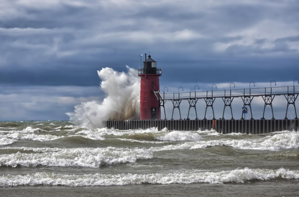 Waves crash against the pier in South Haven