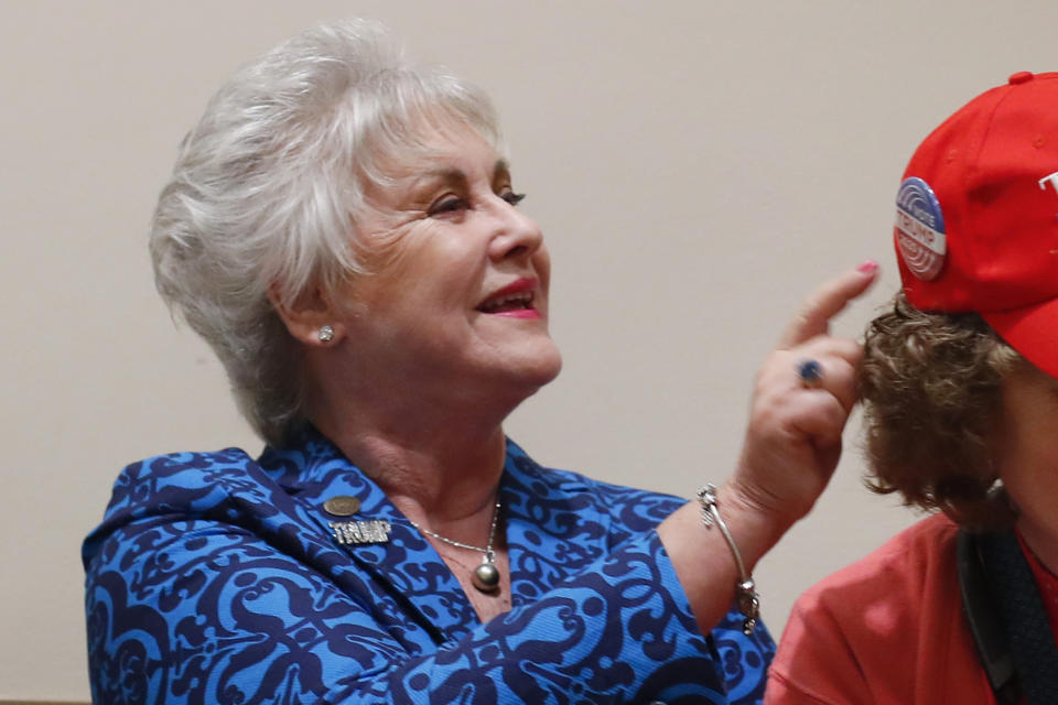 FILE - Kathy Berden looks at buttons on a hat during a training session for Women for Trump, An Evening to Empower, Thursday, Aug. 22, 2019, in Troy, Mich. Michigan Attorney General Dana Nessel has charged 16 Republicans Tuesday, July 18, 2023, with multiple felonies after they are alleged to have submitted false certificates stating they were the state’s presidential electors despite Joe Biden’s 154,000-vote victory in 2020. The group includes Republican National Committeewoman Kathy Berden and Meshawn Maddock, former co-chair of the Michigan Republican Party. (AP Photo/Paul Sancya, File)