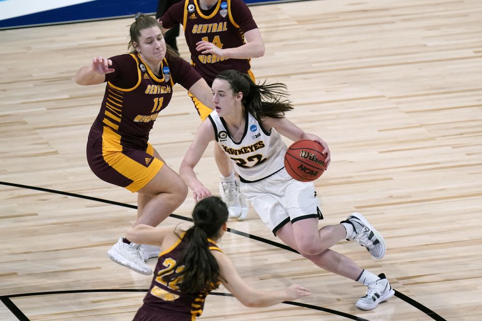 Iowa guard Caitlin Clark (22) drives past Central Michigan guard Micaela Kelly (11) during their first-round game.