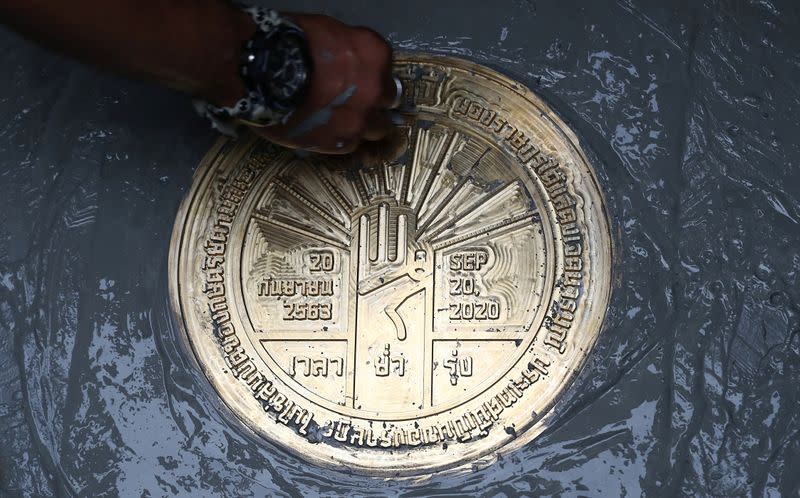 Student leaders install a plaque near the Grand Palace in Bangkok