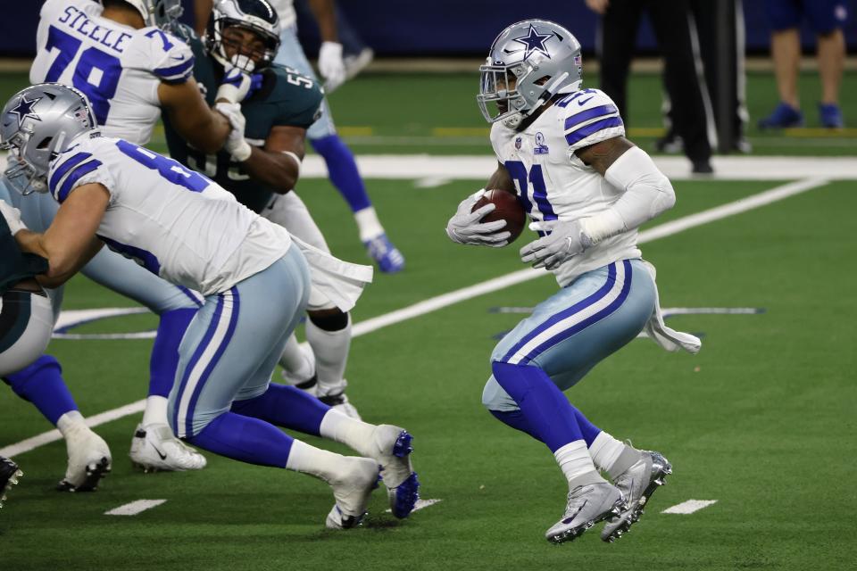 Dallas Cowboys running back Ezekiel Elliott (21) runs the ball in the second half of an NFL football game against the Philadelphia Eagles in Arlington, Texas, Sunday, Dec. 27. 2020. (AP Photo/Michael Ainsworth)