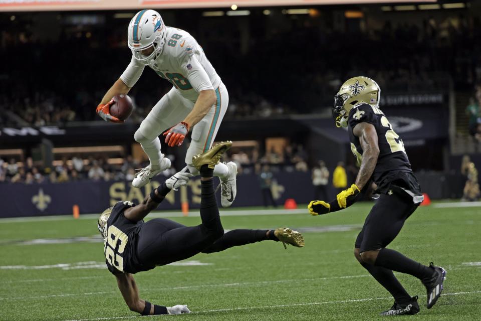 Tight end Mike Gesicki, leaping over Saints cornerback Paulson Adebo (29) during their game in December, might get a franchise tag from the Dolphins.