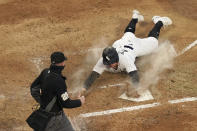 Chicago White Sox's Andrew Vaughn scores off Billy Hamilton's triple as home plate umpire Sean Barber watches during the first inning of a baseball game against the Minnesota Twins Wednesday, May 12, 2021, in Chicago. (AP Photo/Charles Rex Arbogast)