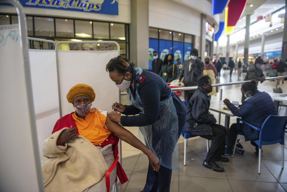 FILE - In this July 6, 2021, file photo, a patient receives a Johnson & Johnson vaccine against COVID-19 in Hammanskraal, South Africa. New infections in South Africa rose to record levels in recent days, part of a rapid rise across the continent, and experts say the surge here has not yet peaked. South Africa reimposed several restrictions, and its vaccination drive is finding its feet after several stumbles. But even as the campaign gathers pace, experts say it's too late to reduce the deadly impact of the current spike. (AP Photo/Alet Pretorius, File)