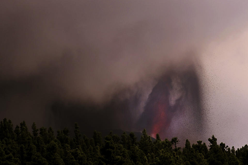 Lava flows from a volcano on the Canary island of La Palma, Spain on Sunday Sept. 26, 2021. A massive cloud of ash prevented flights in and out of the Spanish island of La Palma on Sunday as molten rock continued to be flung high into the air from an erupting volcano. (AP Photo/Daniel Roca)