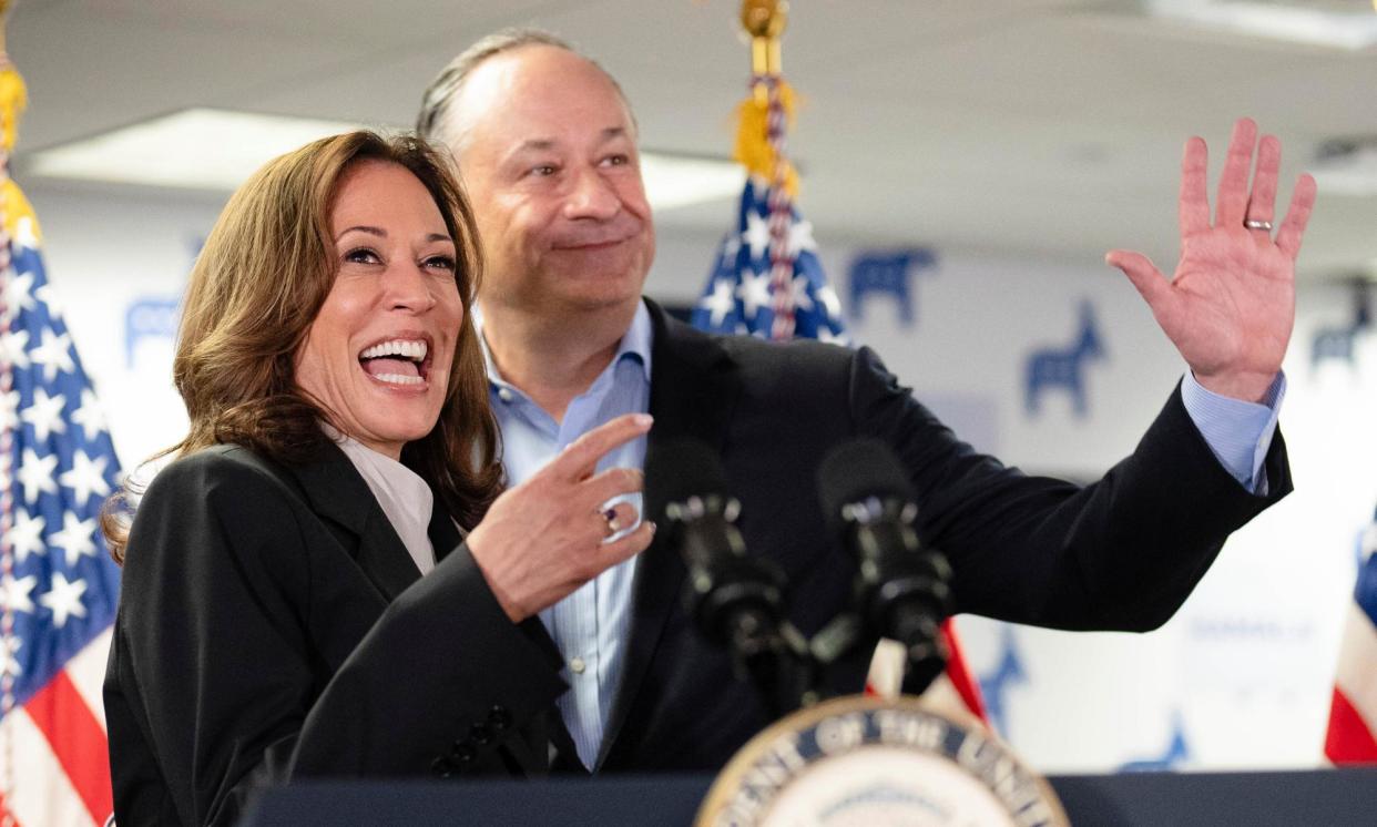 <span>Kamala Harris, left, and Doug Emhoff, speak at her campaign headquarters in Wilmington, Delaware on 22 July 2024.</span><span>Photograph: Erin Schaff/AP</span>