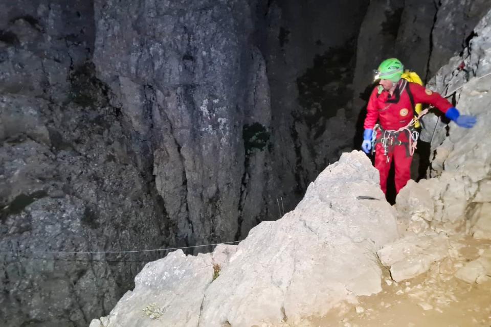 Members of the CNSAS, Italian alpine and speleological rescuers, start to descent on ropes (AP)