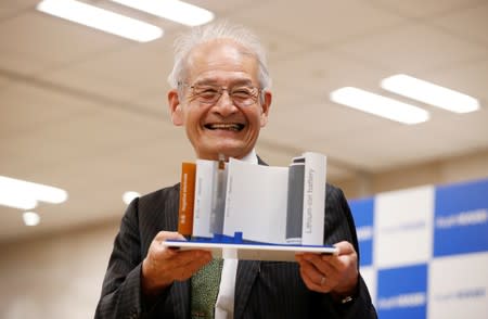 Asahi Kasei honorary fellow Akira Yoshino, 2019 Nobel Prize in Chemistry winner, holds a mock of lithium-ion battery during a news conference in Tokyo