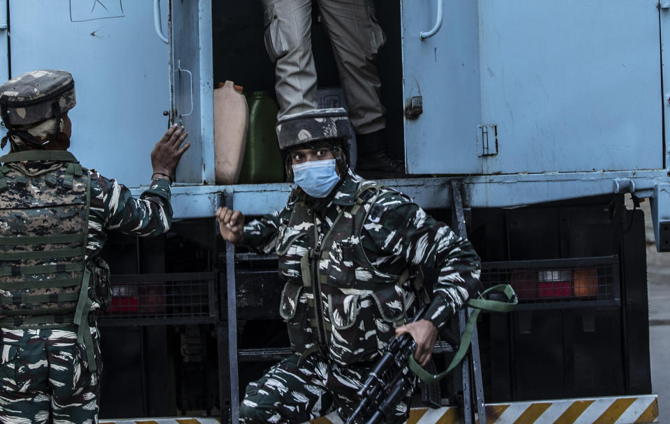 Indian paramilitary soldier arrive near the site of a gunbattle in Srinagar, Indian controlled Kashmir, Thursday, Sept. 17, 2020. The gunfight erupted shortly after scores of counterinsurgency police and soldiers launched an operation based on a tip about the presence of militants in a Srinagar neighborhood, Pankaj Singh, an Indian paramilitary spokesman, said. (AP Photo/Mukhtar Khan)