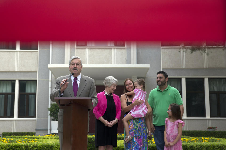 FILE - In this June 28, 2017, file photo, U.S. Ambassador to China Terry Branstad, left, speaks during a photocall and briefing to journalists near his family at the Ambassador's residence in Beijing. Branstad appears to be leaving his post, based on tweets by Secretary of State Mike Pompeo. Pompeo thanked Branstad for more than three years of service on Twitter on Monday, Sept. 14, 2020. (AP Photo/Ng Han Guan, File)