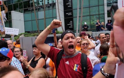 Marcos Carbono, a Venezuelan exile, takes part in a protest against Venezuelan president Nicolas Maduro and the Venezuelan presidential elections in Miami, Florida - Credit:  GASTON DE CARDENAS/AFP