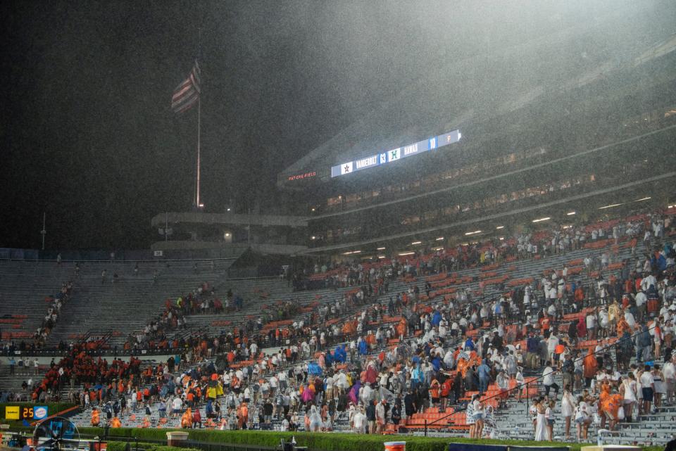 Fans evacuate the stadium as the rain begins to fall as Auburn Tigers take on Mercer Bears at Jordan-Hare Stadium in Auburn, Ala., on Saturday, Sept. 3, 2022. Auburn Tigers leads Mercer Bears 28-7 at halftime.