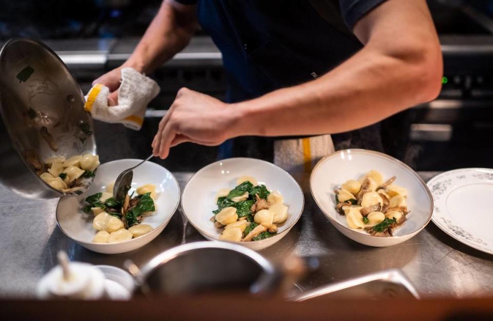 Restaurant Josephine’s Mark Looney prepares three plates of potato-leek vareniki in the kitchen during dinner service Tuesday in Auburn.