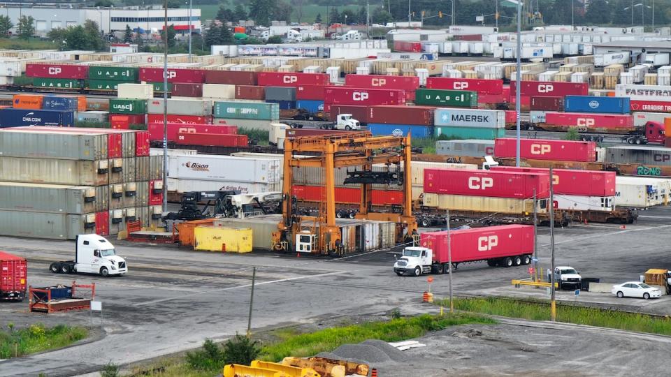 An aerial photo of trains and shipping containers at the CPKC Railway Yard in Vaughan, Ont. Canada's transportation and warehousing sector grew 1.4 per cent in February, a pace that StatsCan said was the largest monthly growth rate since January 2023.  (Patrick Morrell/CBC - image credit)