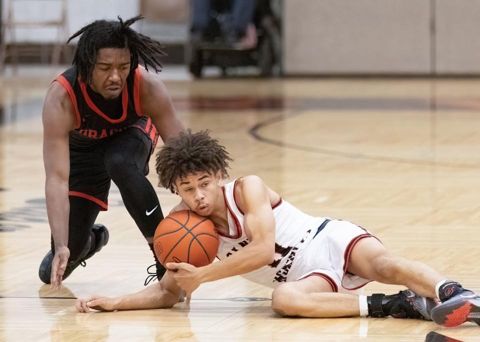 McKinley’s Davey Thompson grabs a loose ball in front of Akron East’s Duke Sales during the Hoover Hoops MLK Classic on Sunday, Jan. 14, 2024.