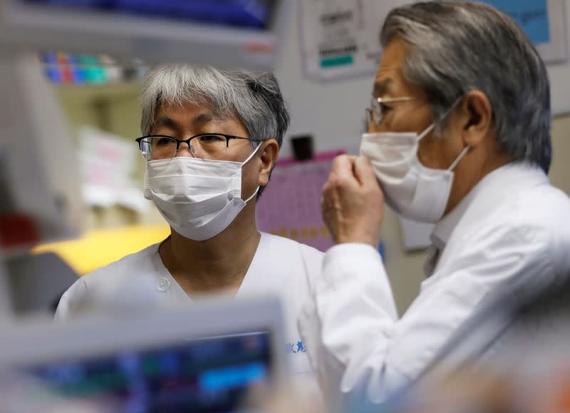 Dr. Shigeki Fujitani talks with Dr. Yasuhiko Taira at the ICU for the coronavirus disease (COVID-19) patients at St. Marianna Medical University Hospital in Kawasaki, Japan