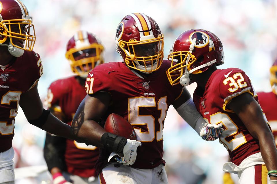 Washington Redskins linebacker Shaun Dion Hamilton (51) is congratulated after intercepting a pass, during the second half at an NFL football game against the Miami Dolphins, Sunday, Oct. 13, 2019, in Miami Gardens, Fla. (AP Photo/Brynn Anderson)