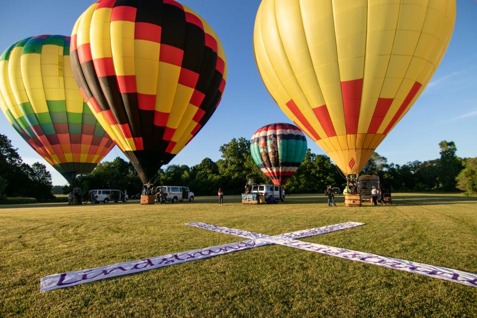 Hot-air balloons, from left, Ralphie's Ride, Fore, Ezy Rider and Overheat were among those launching for a media event as the Michigan Challenge Balloonfest gets underway Friday, June 24, 2022 .