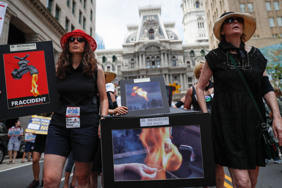 <p>Climate change activists carry signs as they march during a protest in downtown on Sunday, July 24, 2016, in Philadelphia. The Democratic National Convention starts Monday in Philadelphia. (AP Photo/John Minchillo)</p>