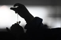 A health worker prepares a sample taken for a COVID-19 test at a free testing center in Buenos Aires, Argentina, Friday, Dec 31, 2021. (AP Photo/Gustavo Garello)