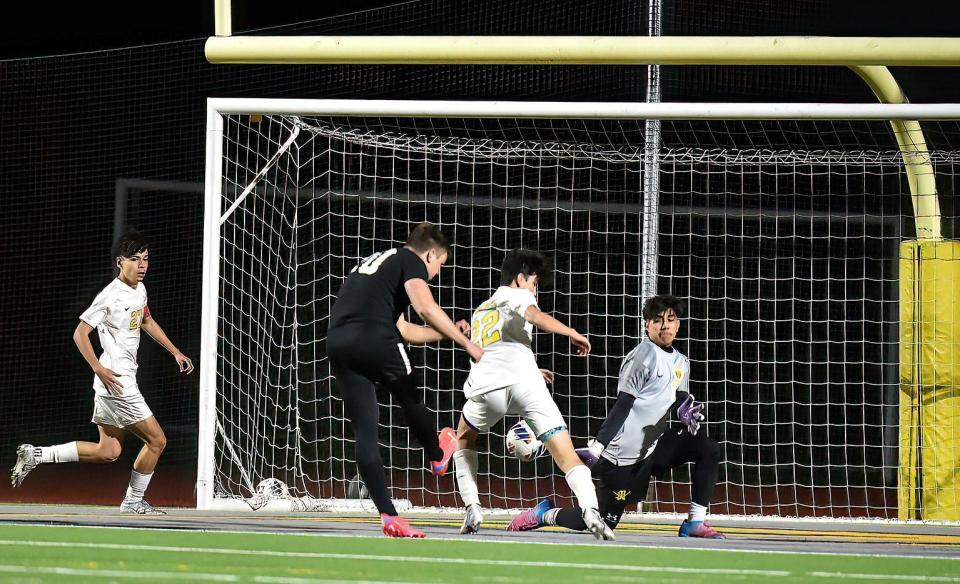 Rowan Heidt sneaks a shot through the legs of a Moorpark defender and past the goalie for the lone goal of Oak Park's 1-0 win Friday night as the Eagles clinched the Coastal Canyon League championship.