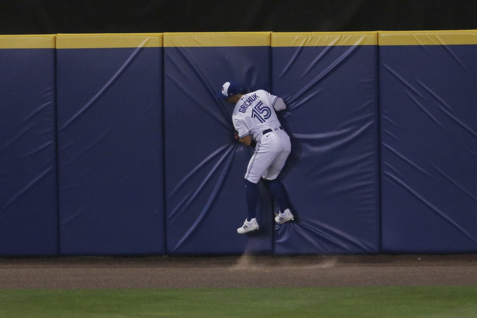 Toronto Blue Jays' Randal Grichuk makes a catch against the wall to seal a 12-4 victory over the Tampa Bay Rays during the ninth inning of a baseball game, Friday, Aug. 14, 2020, in Buffalo, N.Y. (AP Photo/Jeffrey T. Barnes)