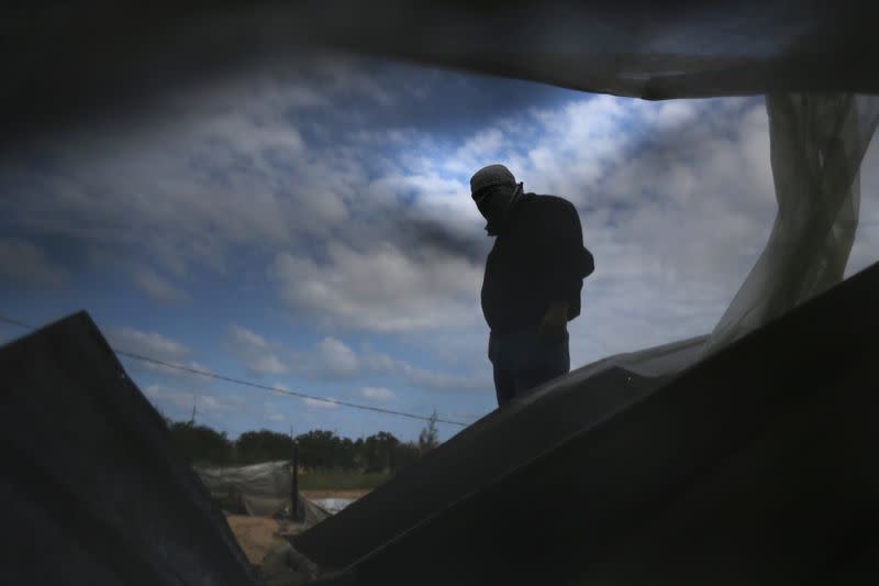 A Palestinian militant surveys an Islamic Jihad site that was targeted in an Israeli air strike in the southern Gaza Strip