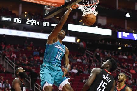 Dec 13, 2017; Houston, TX, USA; Charlotte Hornets center Dwight Howard (12) dunks as Houston Rockets guard James Harden (13), center Clint Capela (15), and guard Chris Paul (3) look on during the fourth quarter at Toyota Center. Shanna Lockwood-USA TODAY Sports